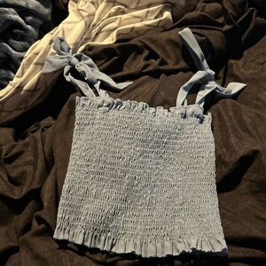 This is a light blue crop top, don’t know the brand, Size- Small
